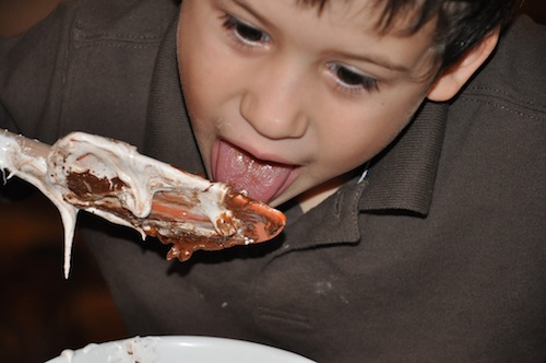 kid licking spoon